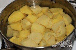 Шаг 1: Очищенный картофель разрезаем на части. Заливаем водой, добавляем немного соли и ставим вариться до готовности.